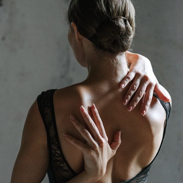 Woman stretching gracefully, embodying flexibility and strength.